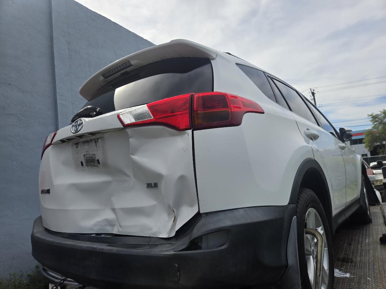 Damaged Toyota RAV4 ready for flatbed pickup in Miami-Dade